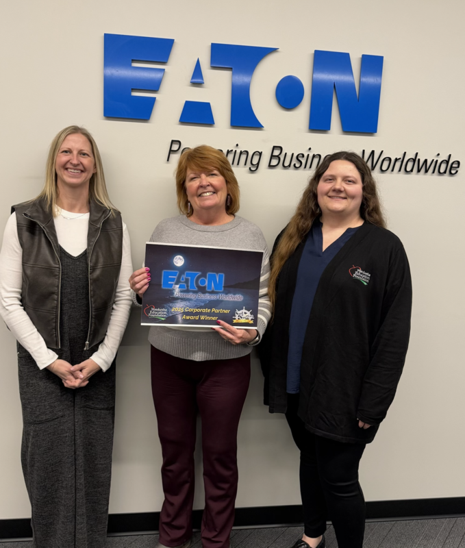 Jackie Pride from Eaton accepts the 2025 Corporate Partner Award from nominator Mollie Haubsenschild (Left) and WEF Board President Janaka Subotnik (right)