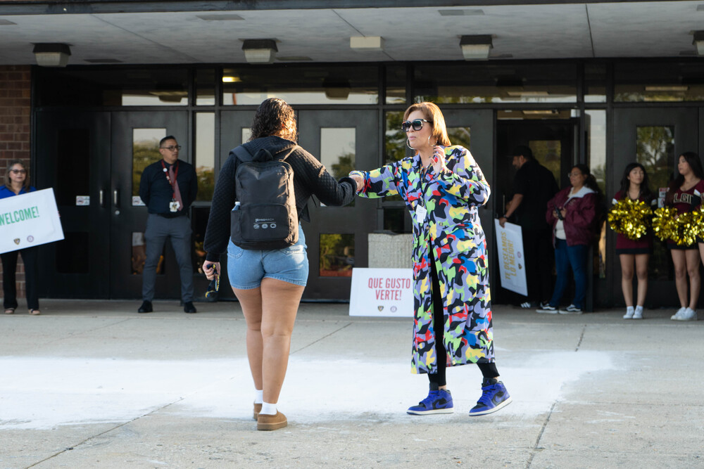 Teacher fist bumps student