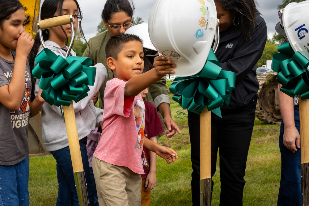 A child grabs a constructoin hat