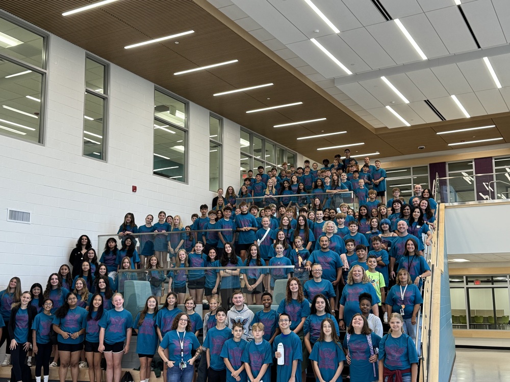 Students on the stairs posing for a picture 