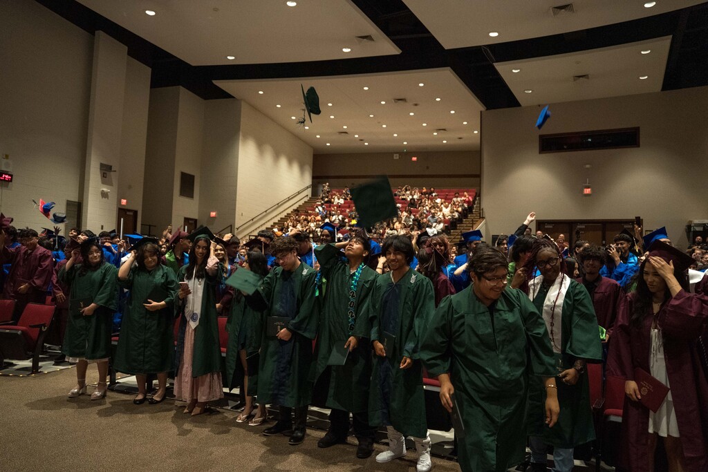 Students toss their graduation caps at their graduation ceremony