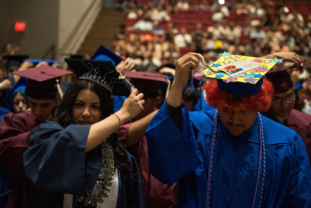 Students move their tassle from left to right at their high school graduation ceremony