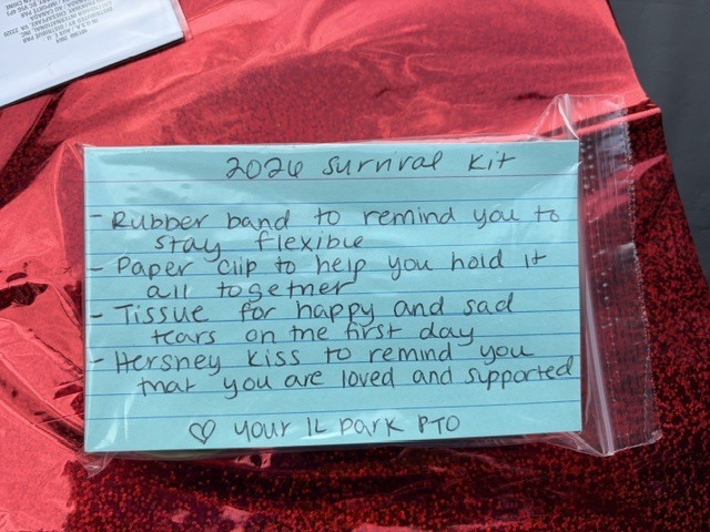 A red cloth displays a plastic bag with a note listing items in a 2020 survival kit.