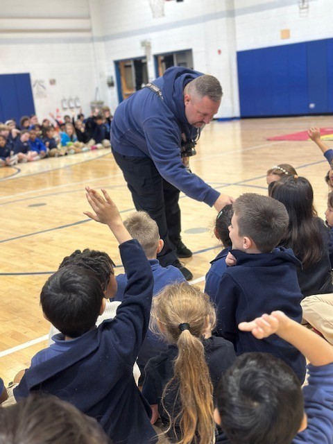 Students answer questions from Fireman Tim