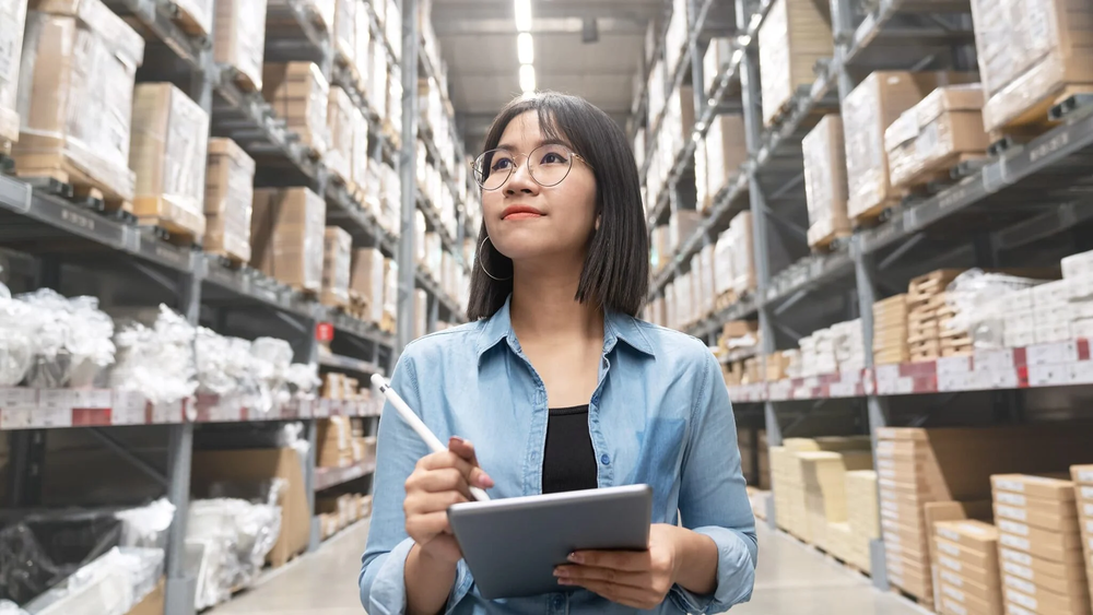 (image of a woman taking inventory in a warehouse)