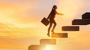 (silhouette of a woman walking up some stairs with a sunset in the background)