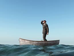 (Man standing in a boat looking to see which way to go)