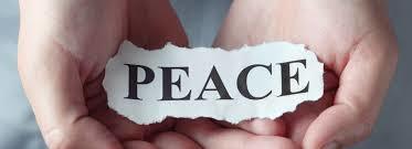 Two hands holding the word Peace