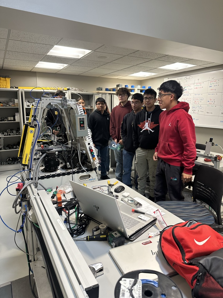 Students being taught by former SCHS grad William Mateo about mechatronics at Central Community College