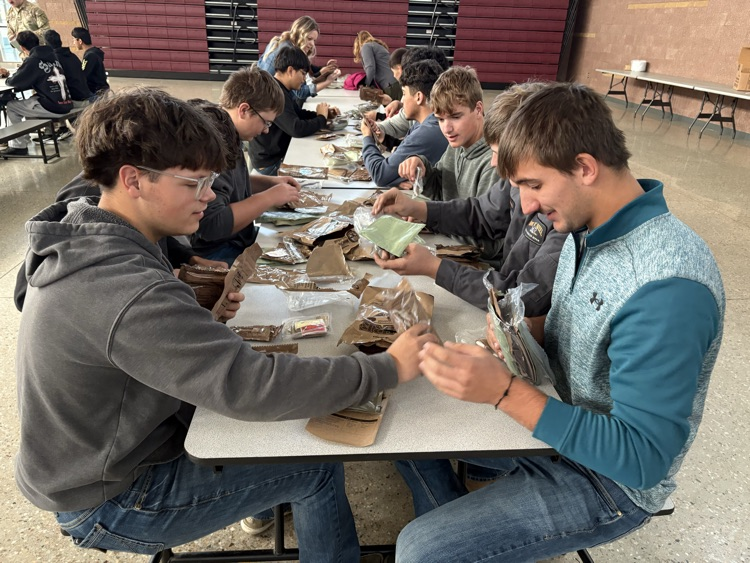 Students taste testing MREs at the National Guard Armory.
