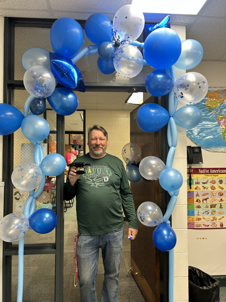 Mr. Baptiste with hisi blue celebration balloon arch