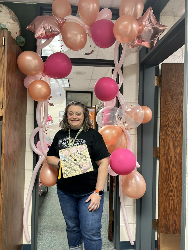 Mrs. Wemhoff with her pink celebration balloon arch