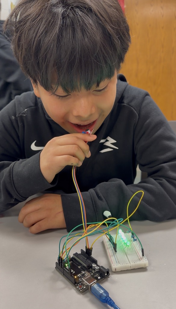 This young boy is immersed in the world of technology, showcasing the importance of digital literacy in today's age.