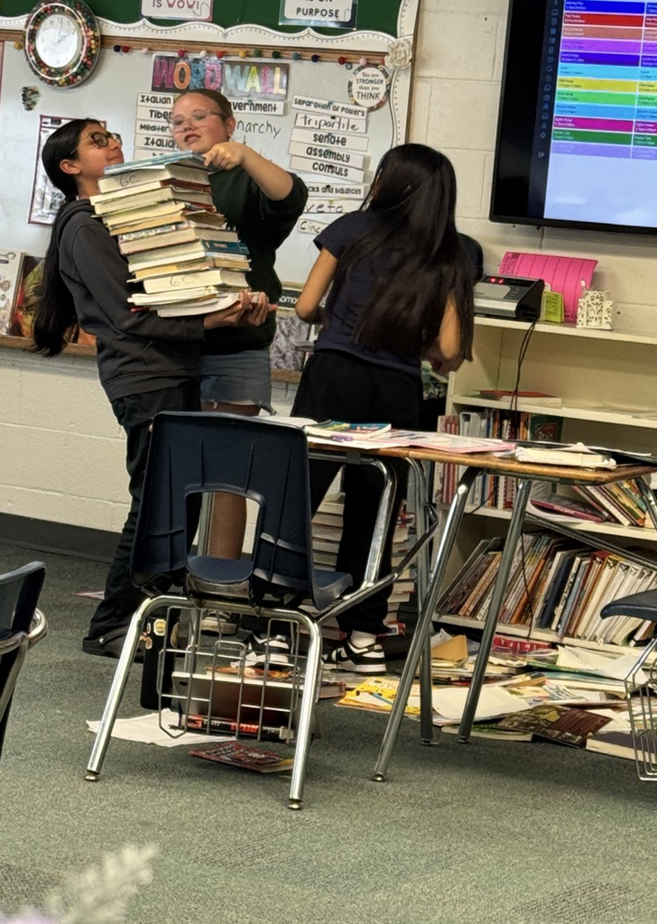 6th graders weighing books to 90 pounds to represent a Roman soldier's back pack. 