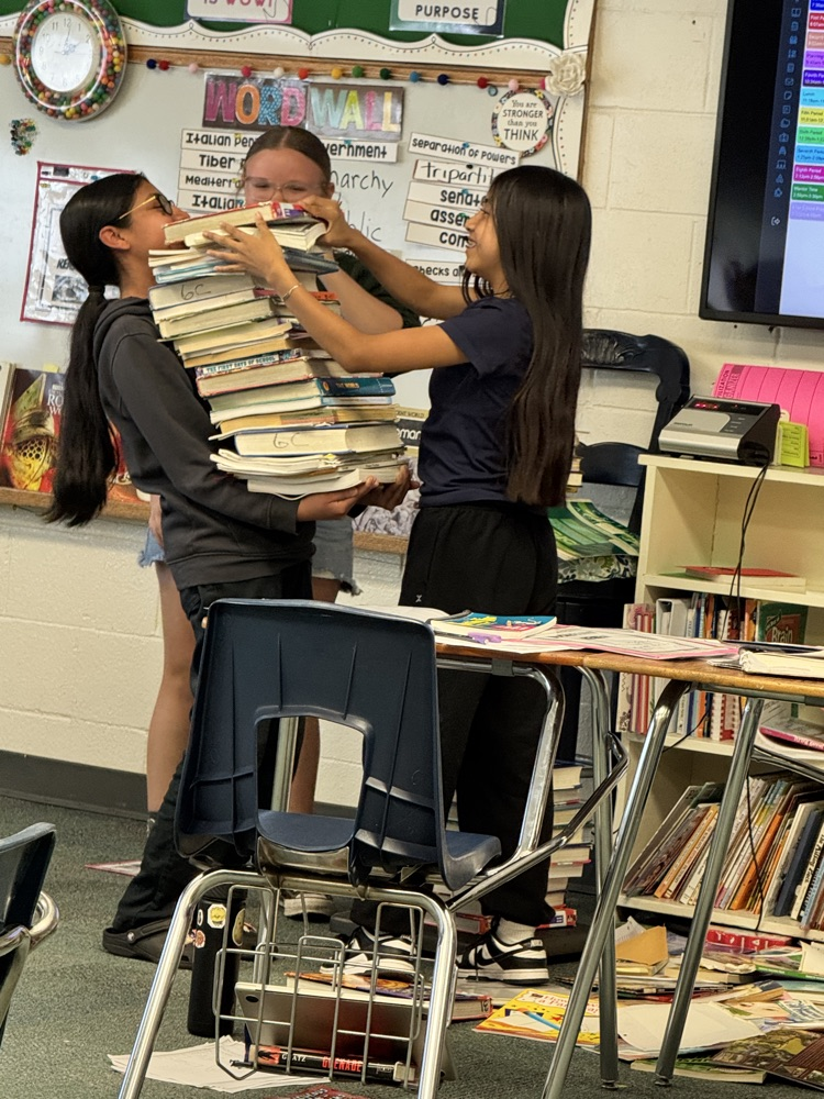 6th graders weighing books to 90 pounds to represent a Roman soldier's back pack