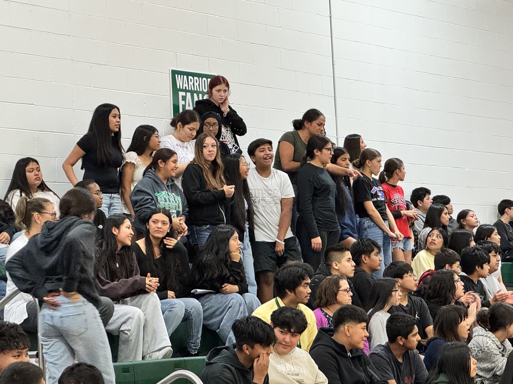 students cheering for the staff vs. student volleyball game