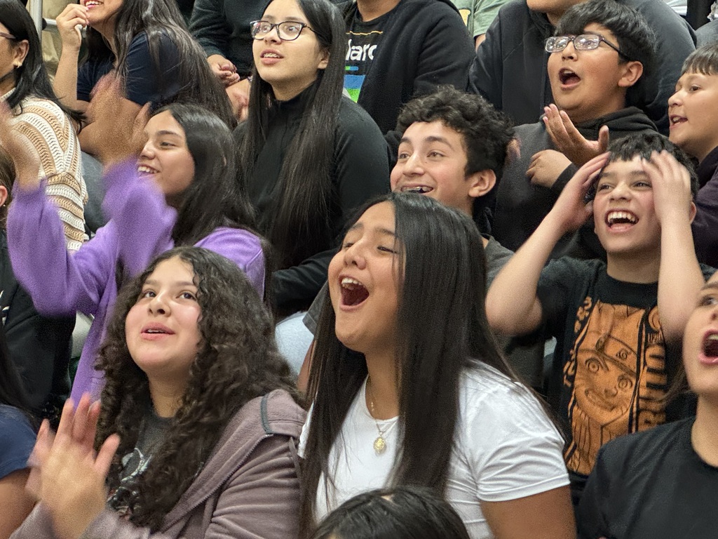 students cheering for the staff vs. student volleyball game