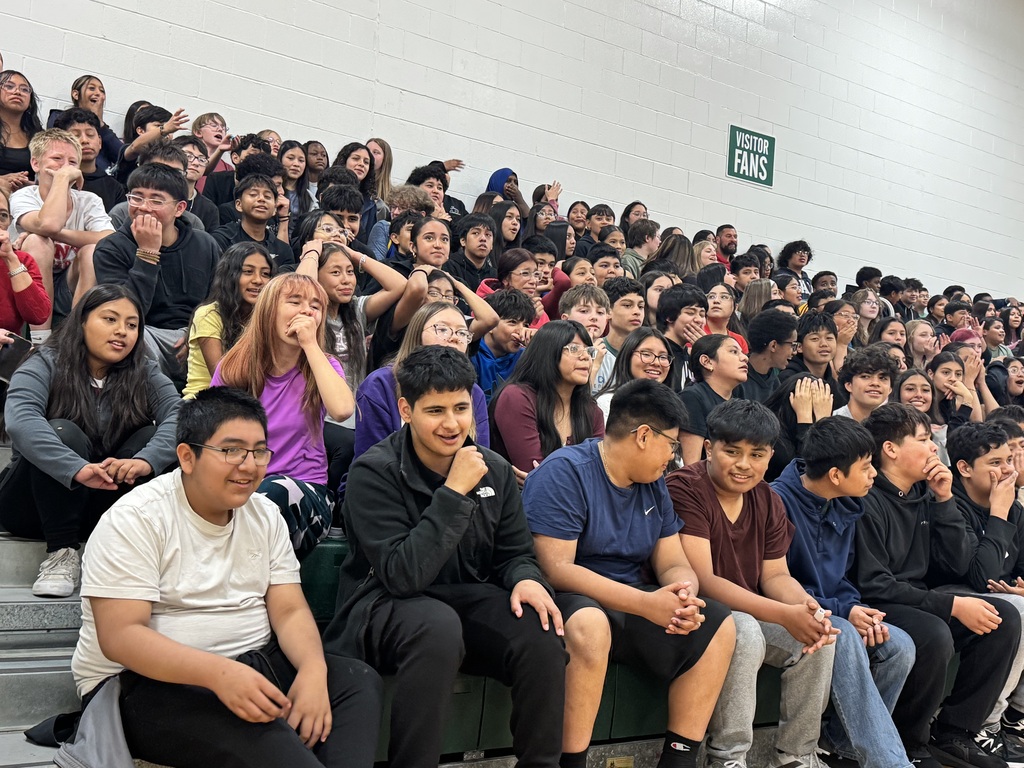 students cheering for the staff vs. student volleyball game