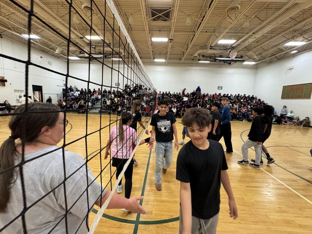 students and staff showing good sportsmanship after the  staff vs. student volleyball game