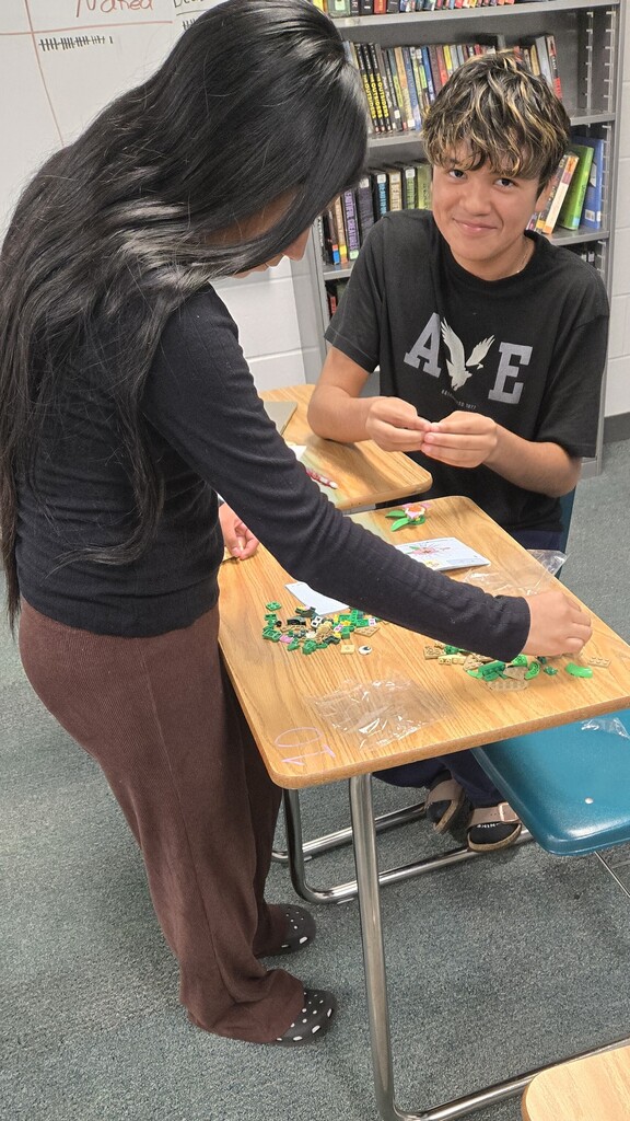 two students putting together legos