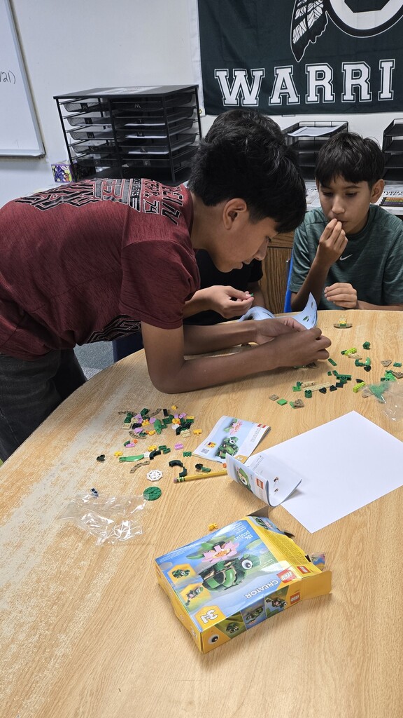 two students putting together legos