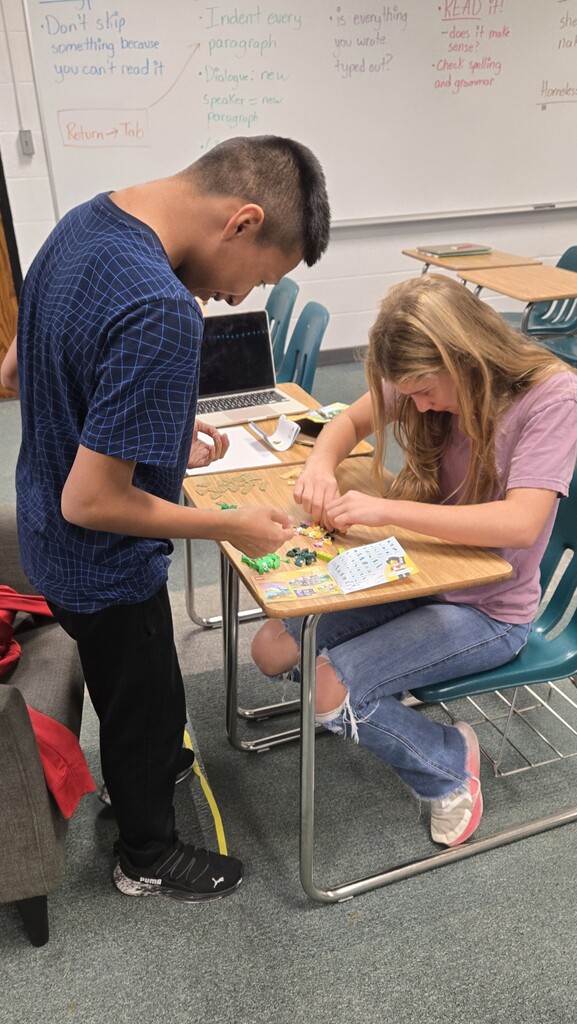 two students putting together legos