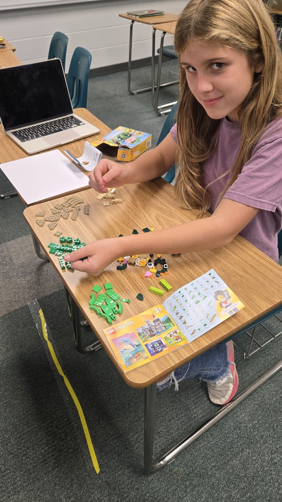 a student putting together legos
