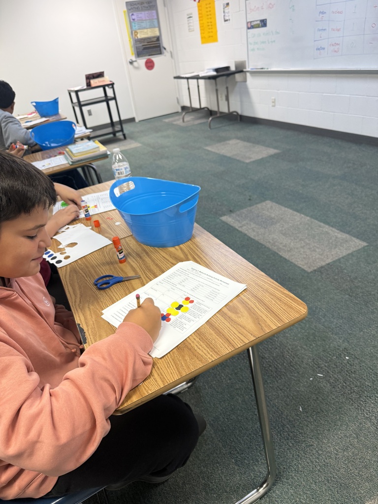 students using paper atom models to build simple molecules