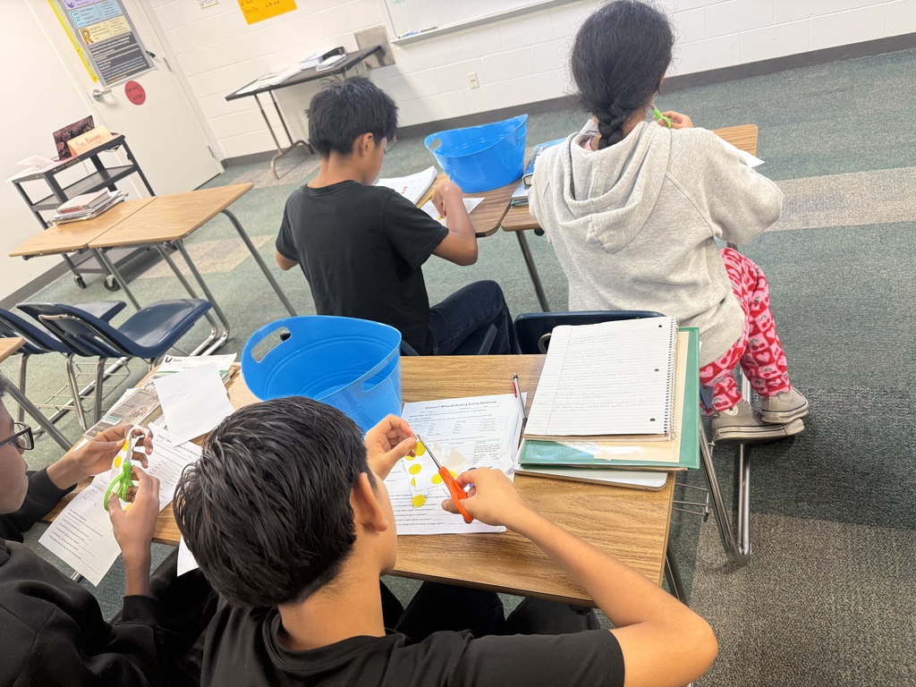 students using paper atom models to build simple molecules