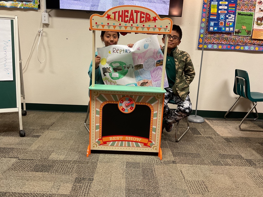 Students displaying their posters.