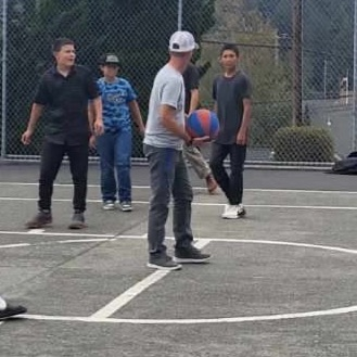 Mr. B and kids playing basketball