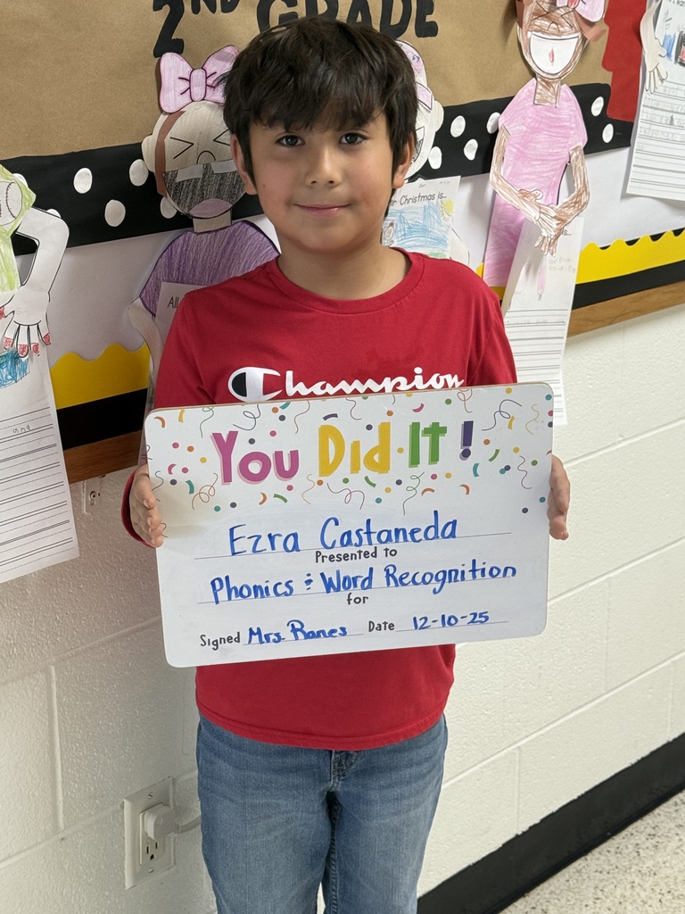 boy in red shirt, with a sign