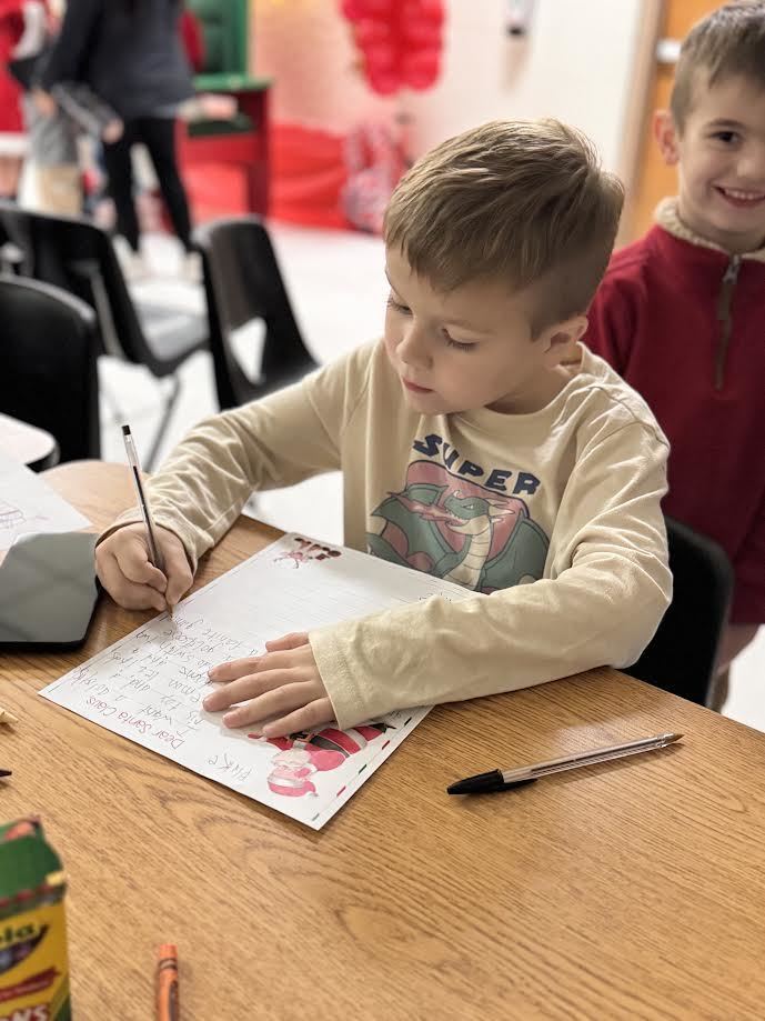 young man writing a letter to santa