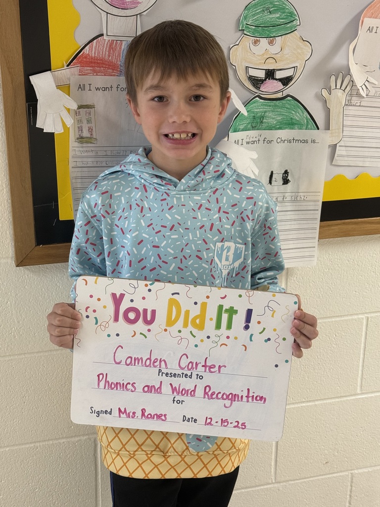 smiling boy , holding sign