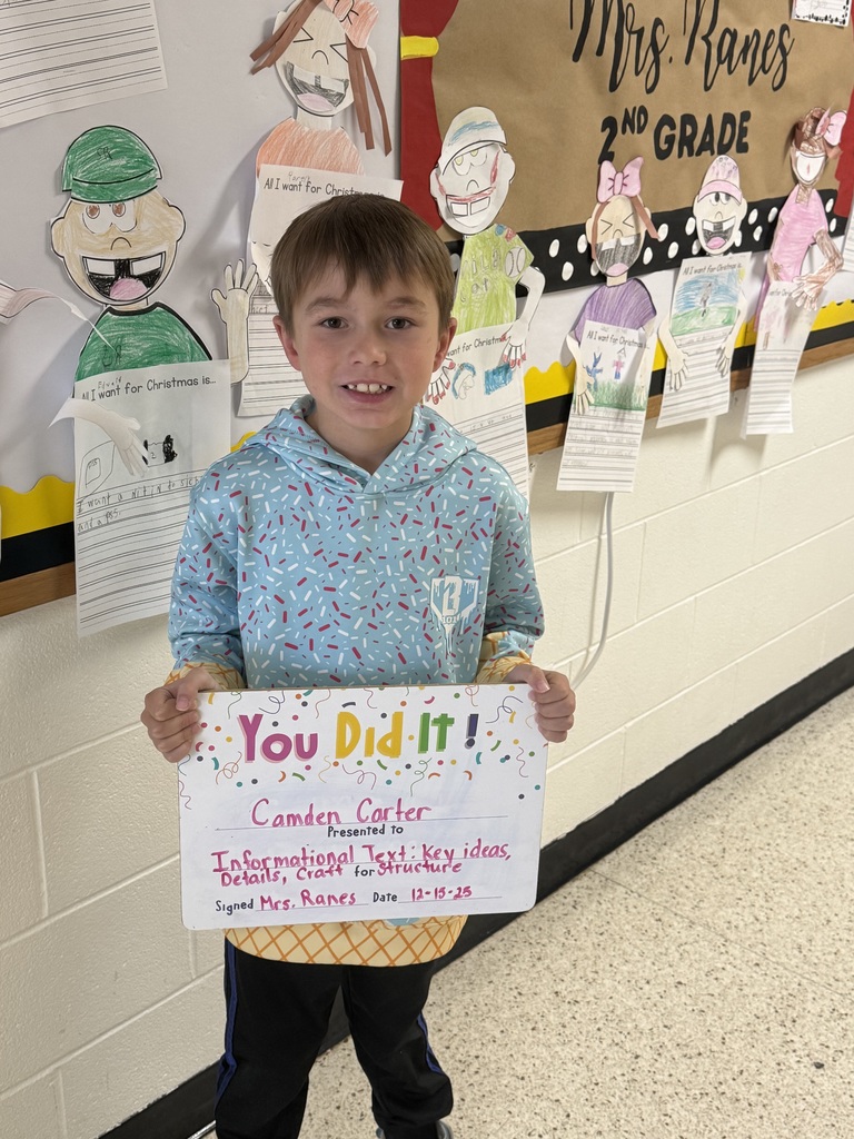 smiling boy holding sign