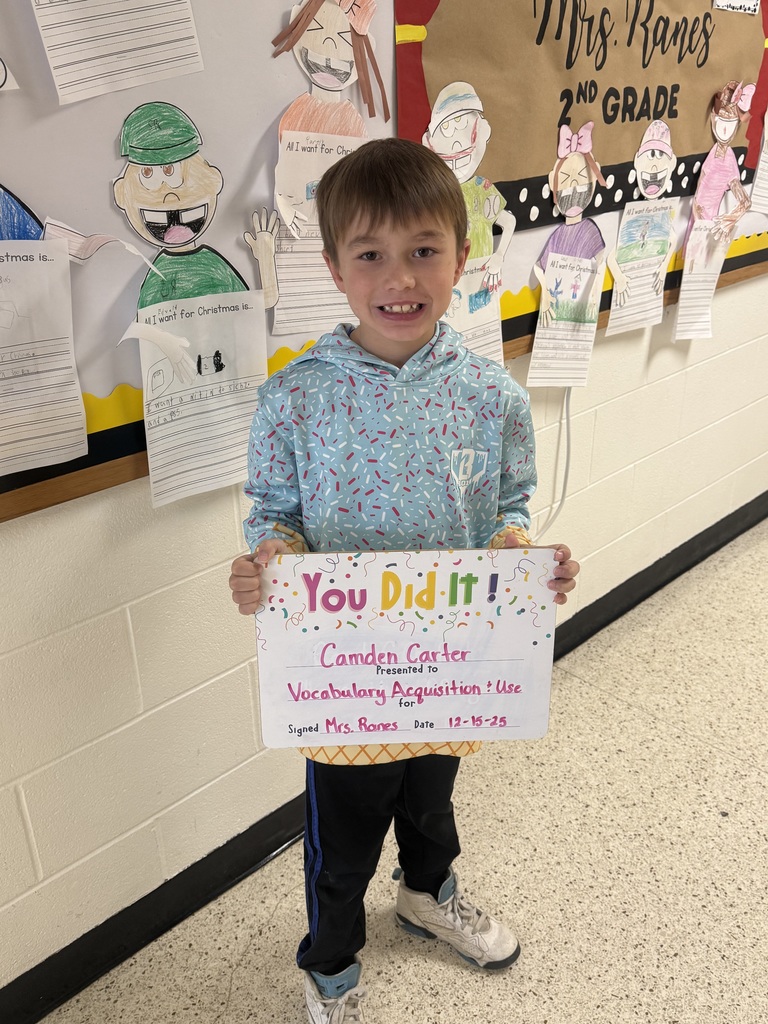 smiling boy holding sign