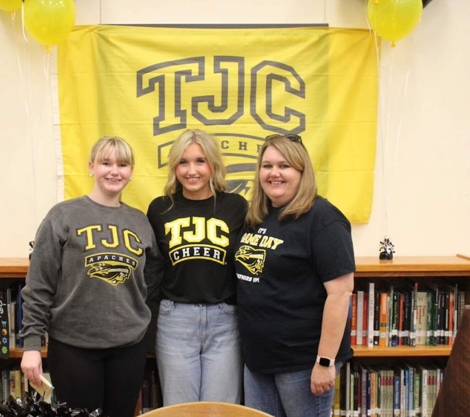pitcure of a blonde woman wearing a black tshirt standing next to a teenage blonde female in a black shirt and another blonde teenager with her hair pulled back in a grey sweatshirt