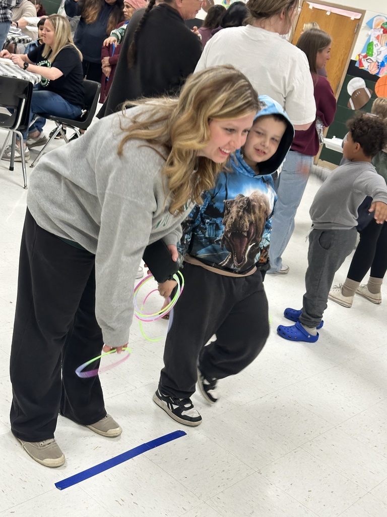 adult female and child playing ring toss