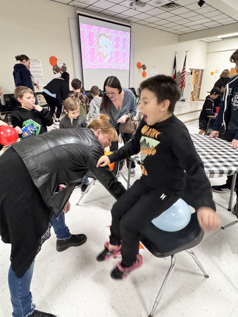 adult female and child playing a game of sitting on a ballon to pop it.