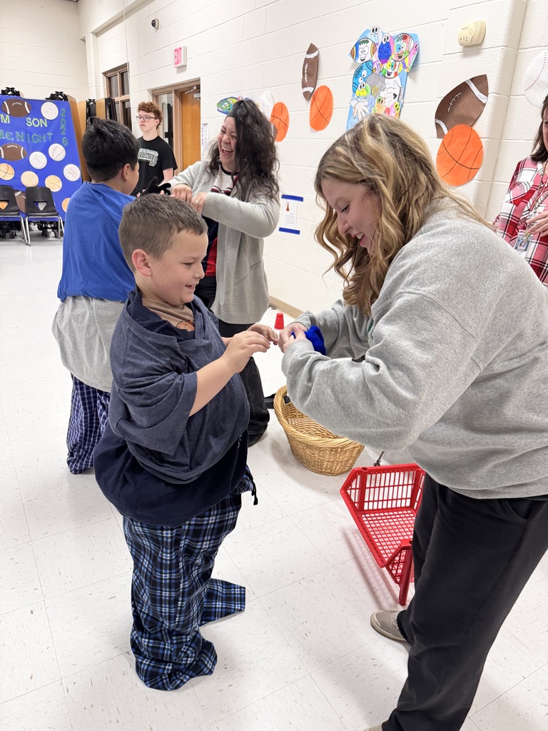 parents and children playing a game while putting on layers of clothes