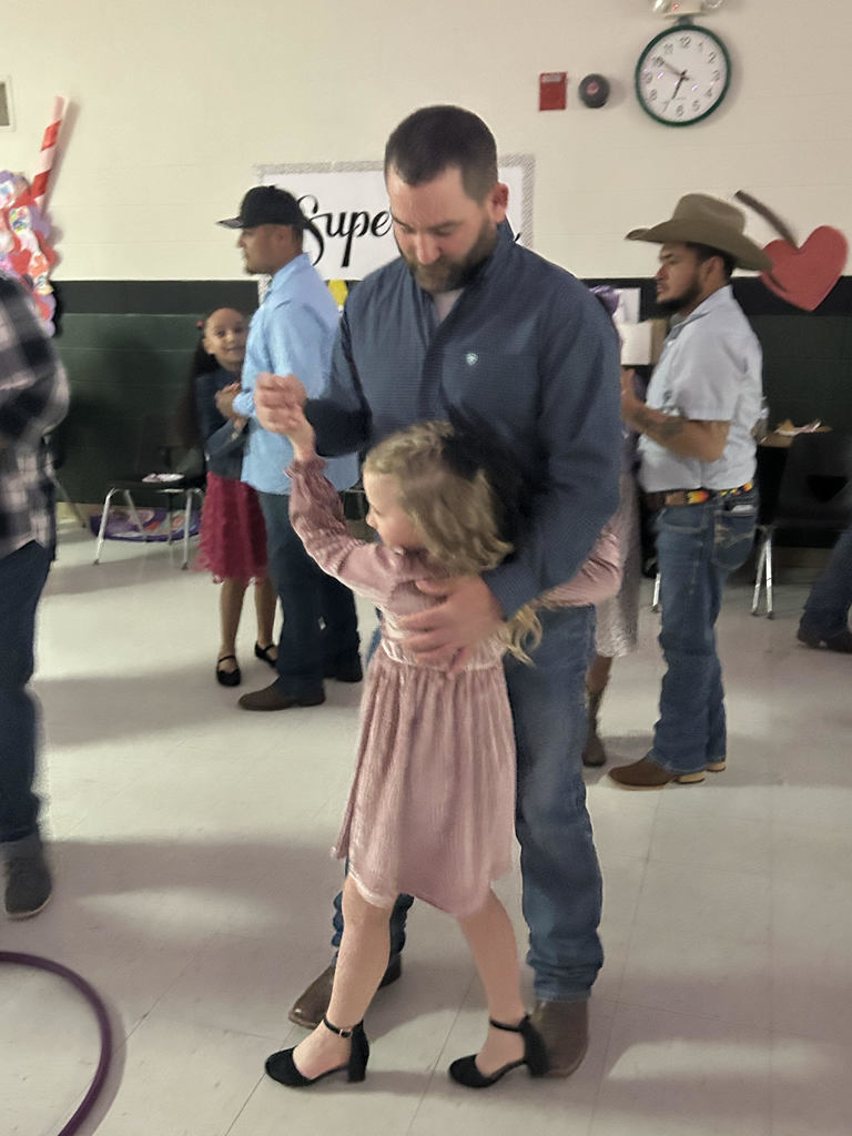 young girl dancing with her dad