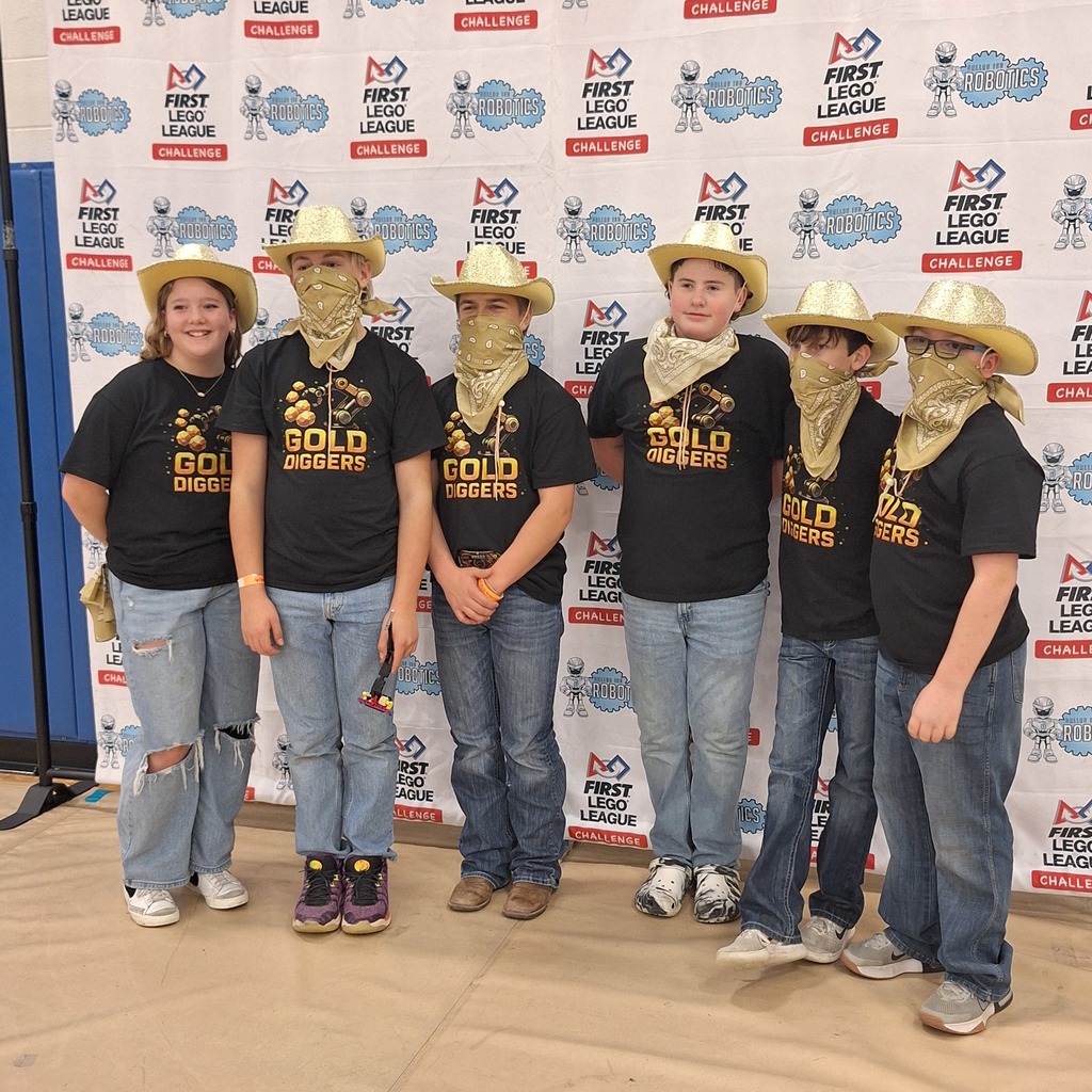 Students dress in black shirts and gold hats