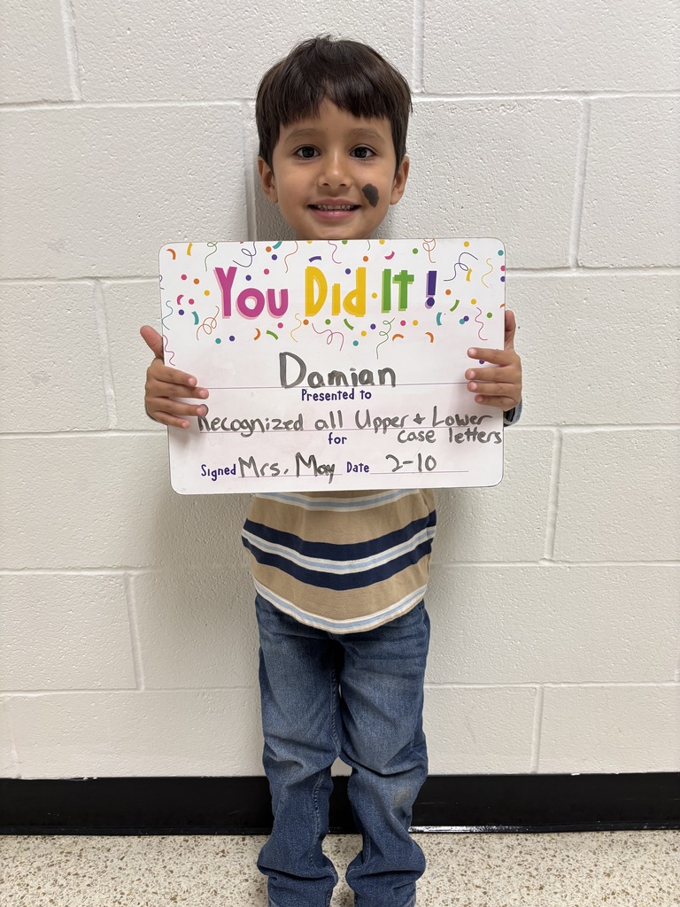 child holding a celebration board