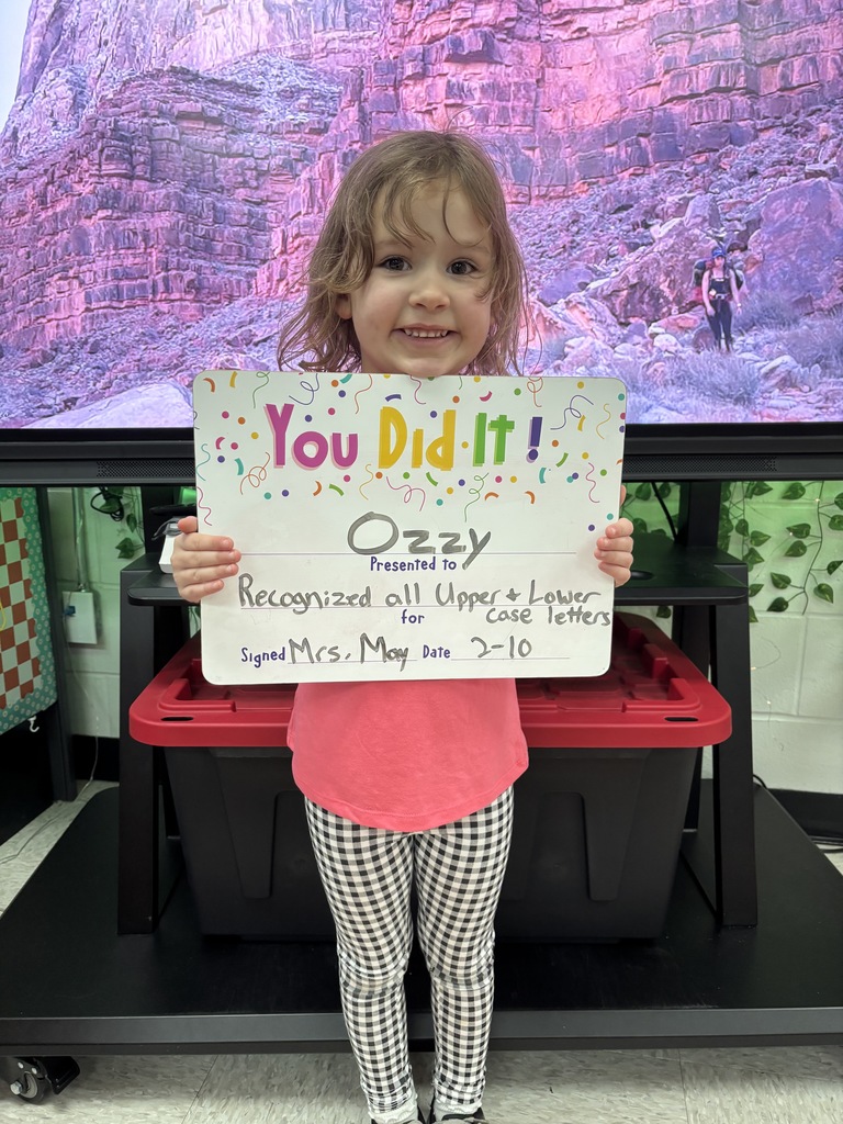 child holding a celebration board
