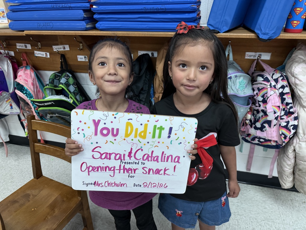 children holding a celebration board