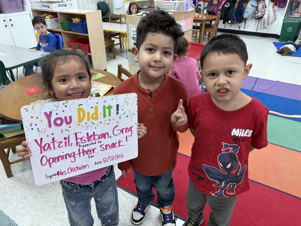 children holding a celebration board