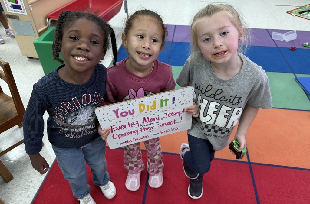 children holding a celebration board
