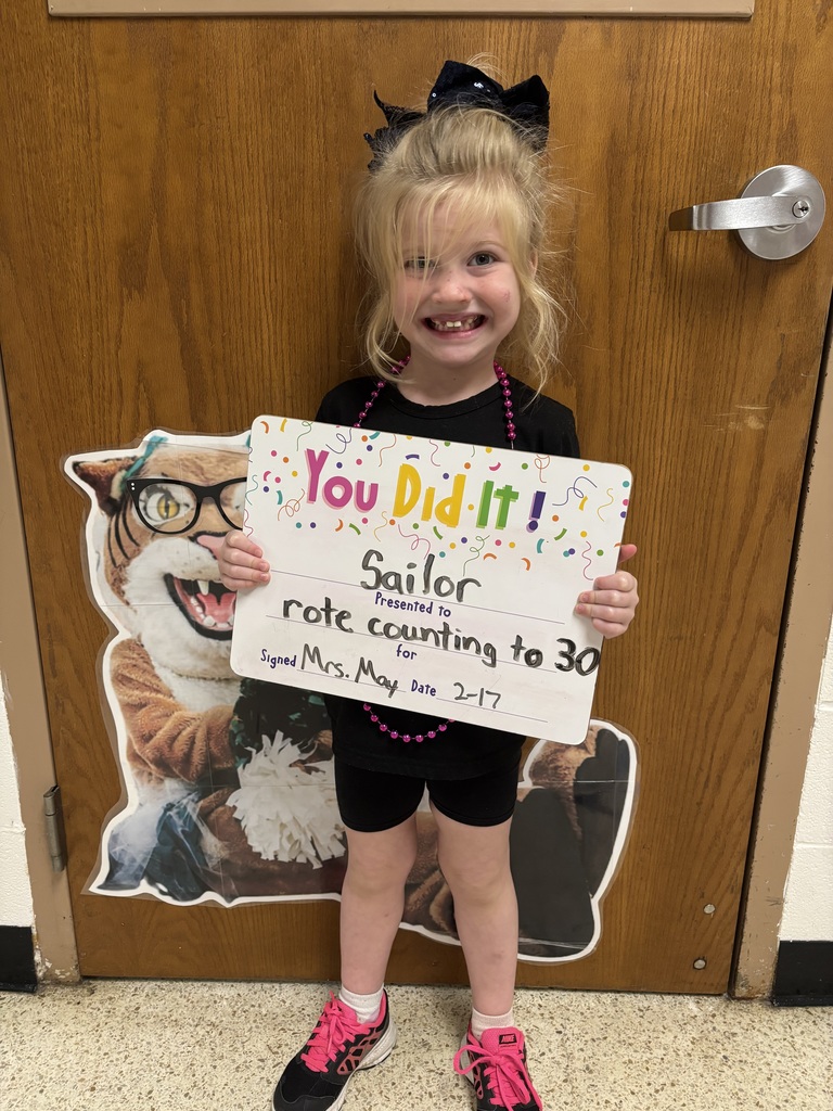 SMILING CHILD HOLDING CELEBRATION BOARD