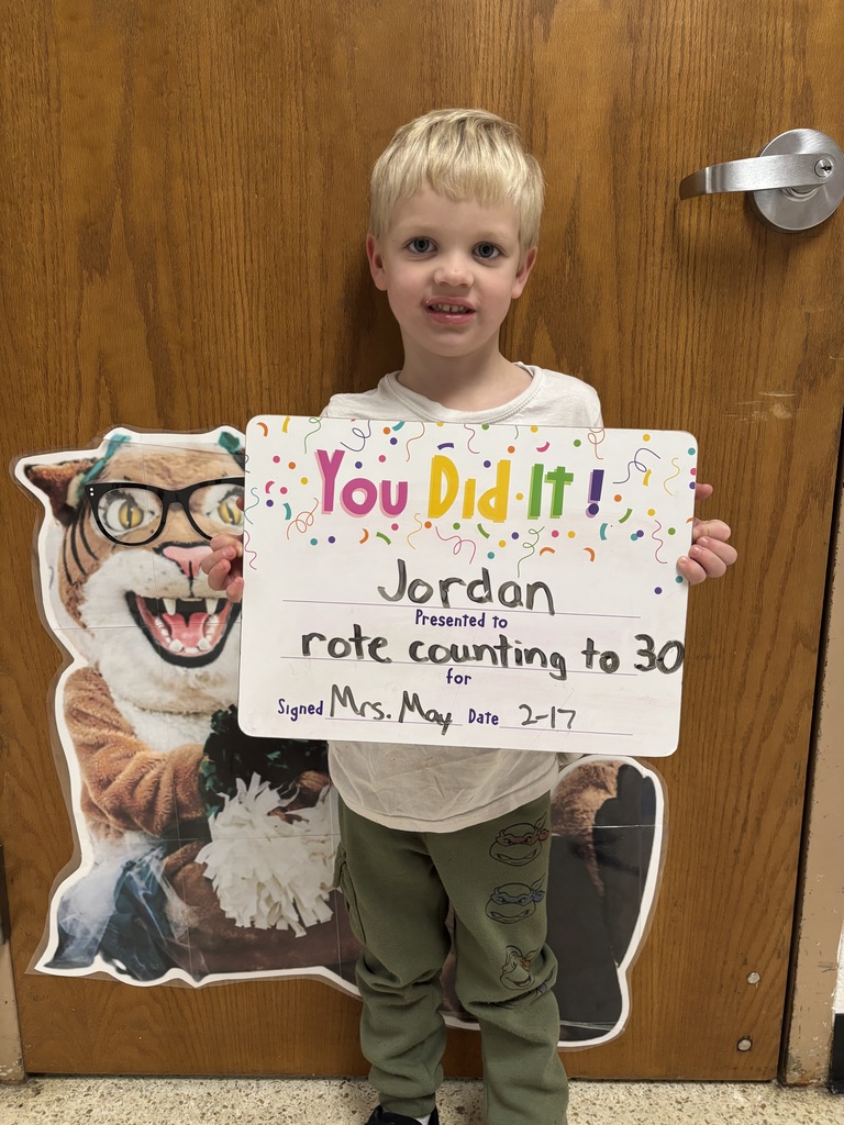SMILING CHILD HOLDING CELEBRATION BOARD