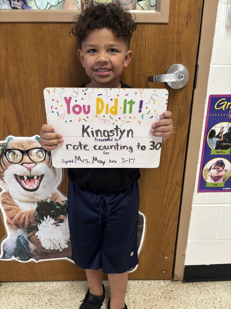 SMILING CHILD HOLDING CELEBRATION BOARD